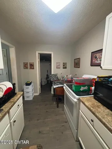 a kitchen filled with a white stove top oven