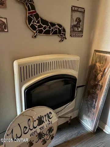 a view of a bedroom with wooden floor and a window
