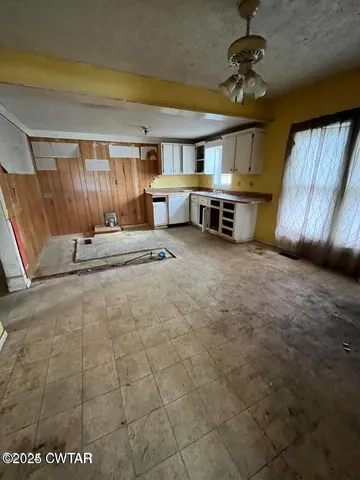 a view of a kitchen with a sink and a window