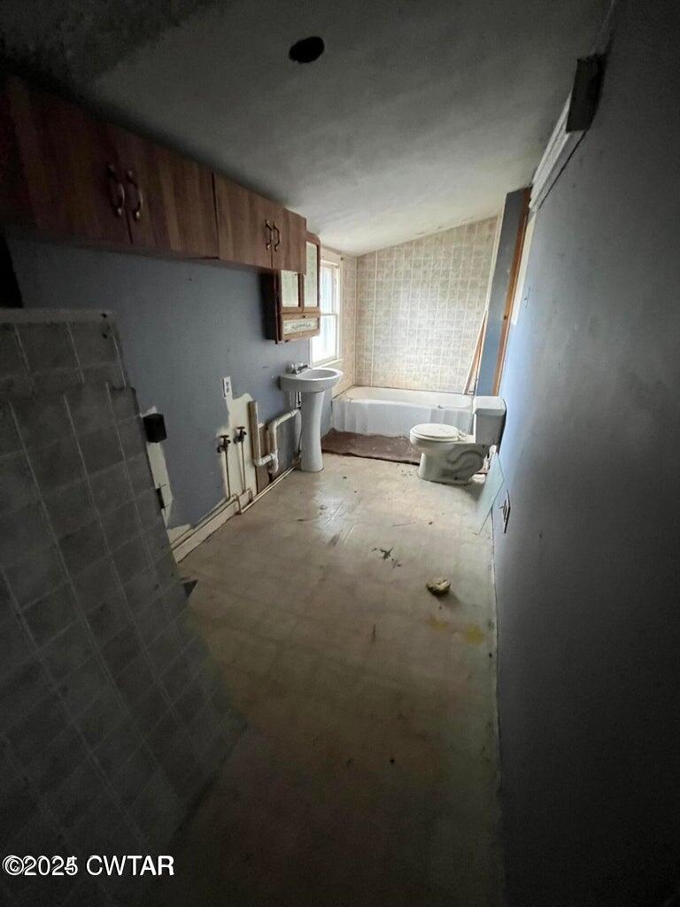 52 South Pleasant Street Decaturville, TN 38329 - Photo 6 of 46 a room with water heater and wooden cabinets