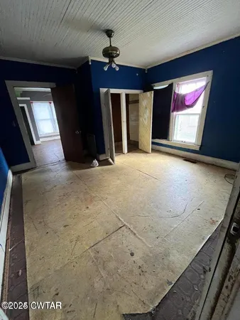 a view of an empty room and a window
