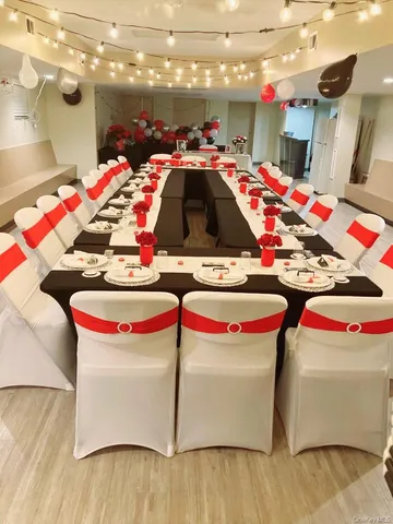a utility room with stainless steel appliances kitchen island a stove and a wooden floor