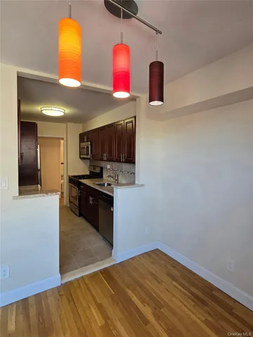 a kitchen with stainless steel appliances kitchen island wooden cabinets and a sink