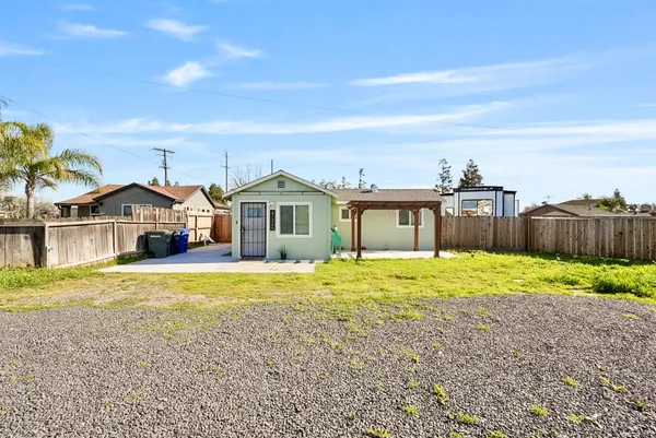 a front view of a house with a yard and a garage