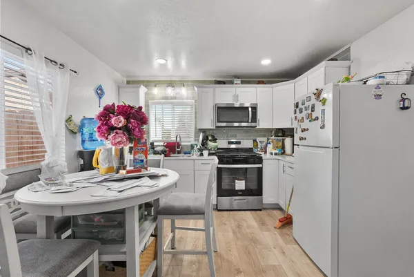 a kitchen with stainless steel appliances a stove refrigerator sink and microwave