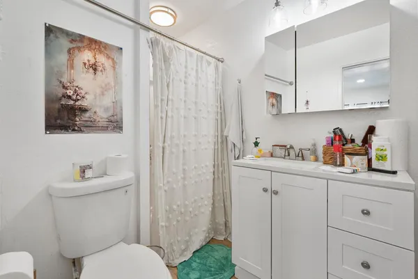 a bathroom with a toilet sink and mirror