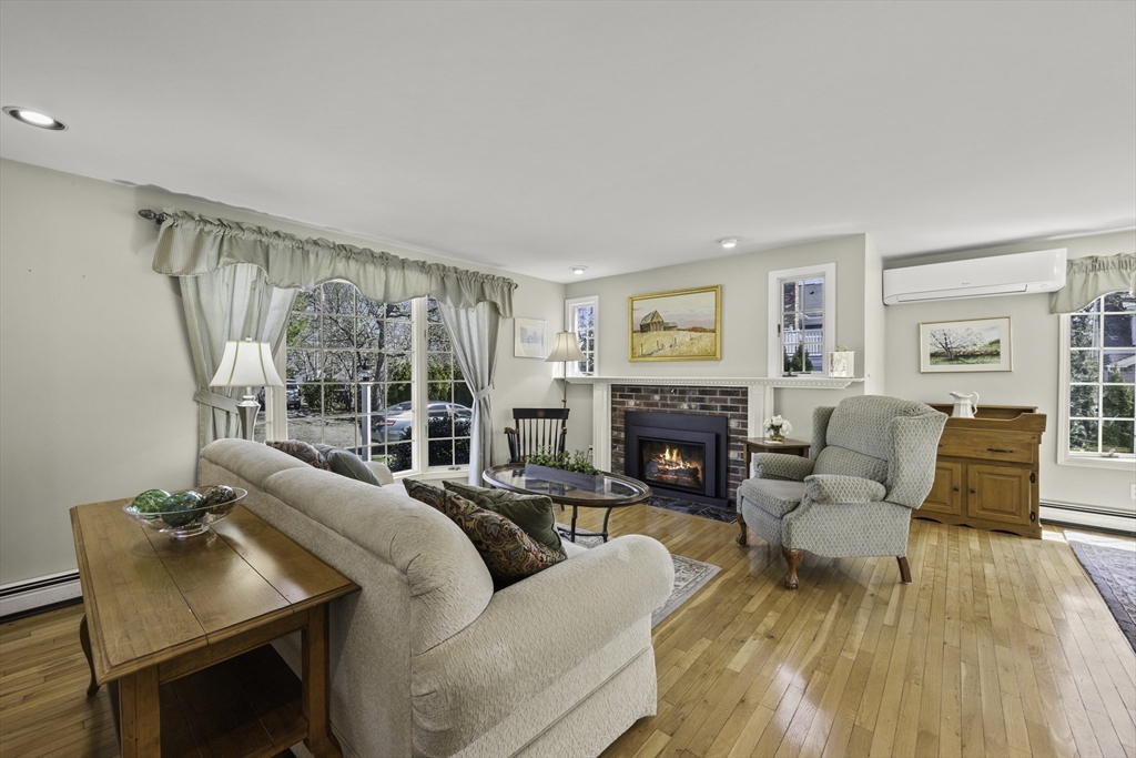 275 Lower County Road Harwich Port, MA 02646 - Photo 3 of 32 a living room with furniture and a fireplace