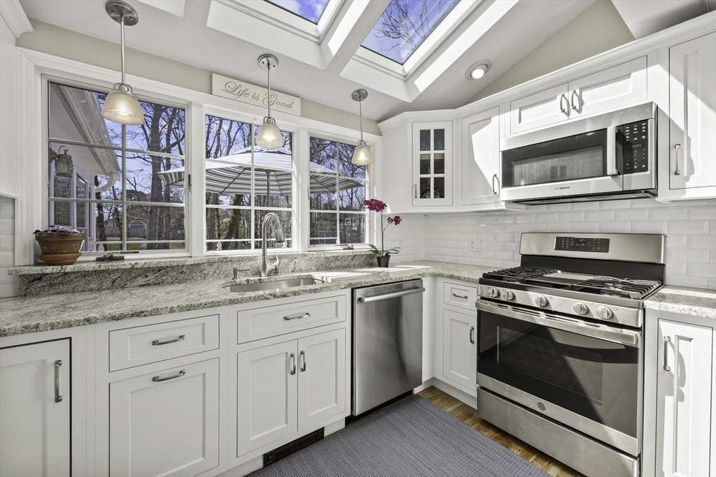 275 Lower County Road Harwich Port, MA 02646 - Photo 8 of 32 a kitchen with stainless steel appliances granite countertop a stove and a sink