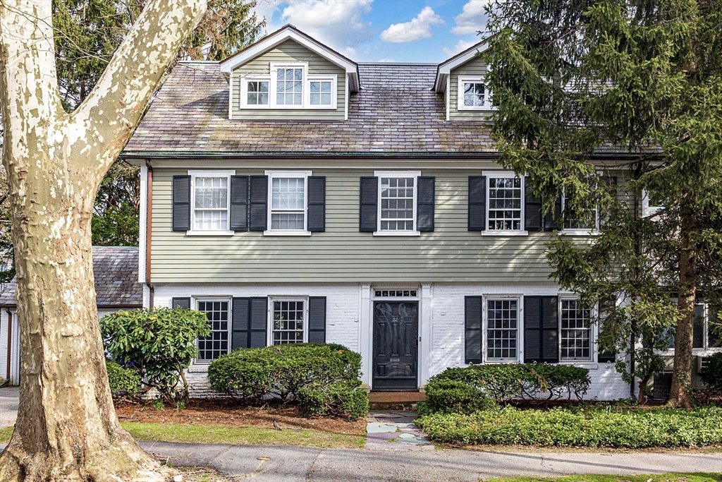 22 Lowell Road Brookline, MA 02445 - Photo 1 of 2 a front view of a house with plants and trees