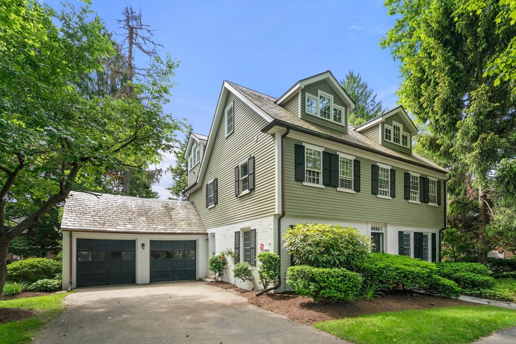 22 Lowell Road Brookline, MA 02445 - Photo 2 of 2 a front view of a house with a garden and plants