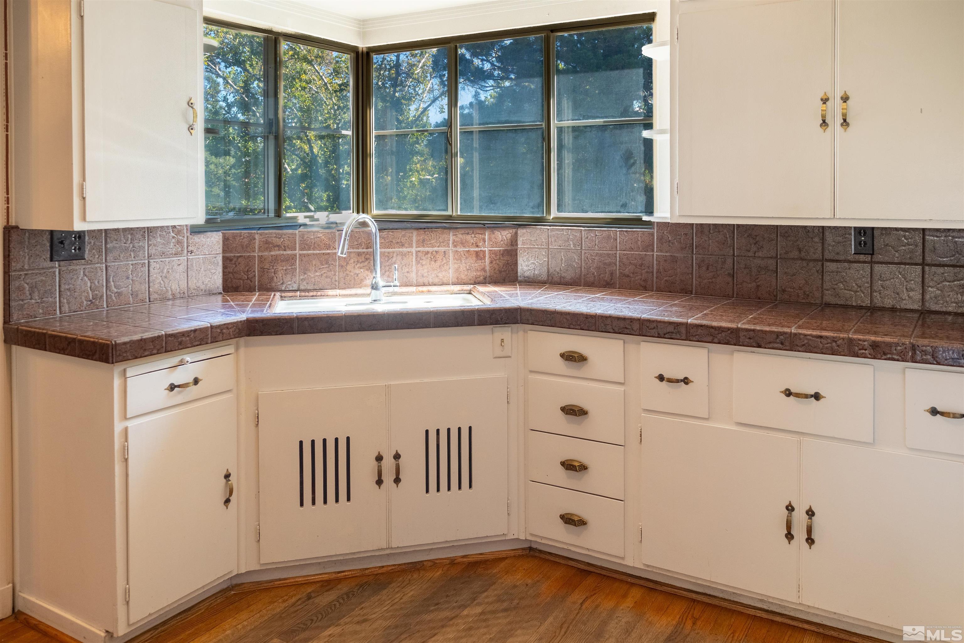 175 Mark Twain Avenue Reno, NV 89509 - Photo 13 of 27 a kitchen with granite countertop white cabinets and a window