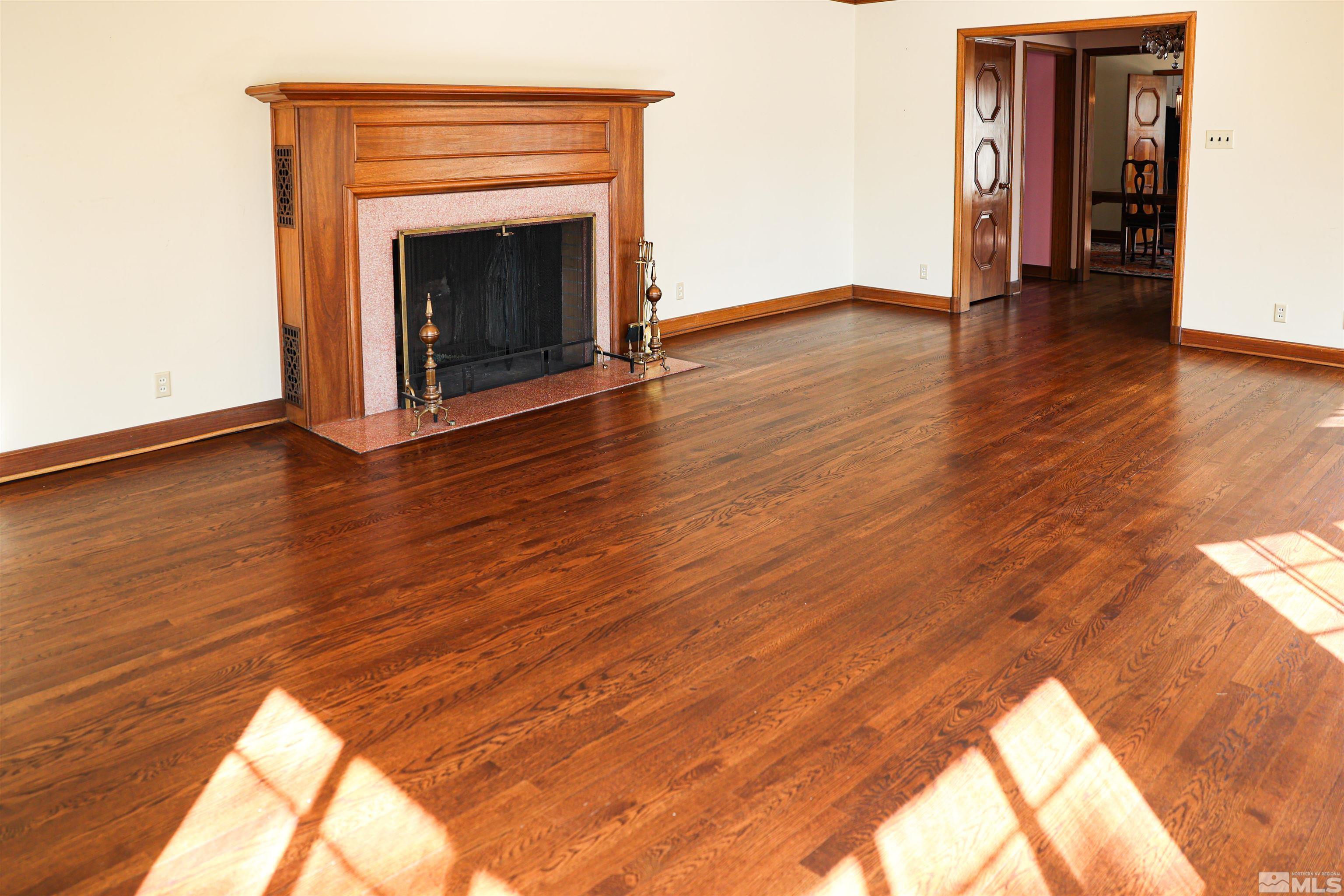 175 Mark Twain Avenue Reno, NV 89509 - Photo 8 of 27 a view of an empty room with wooden floor and a fireplace