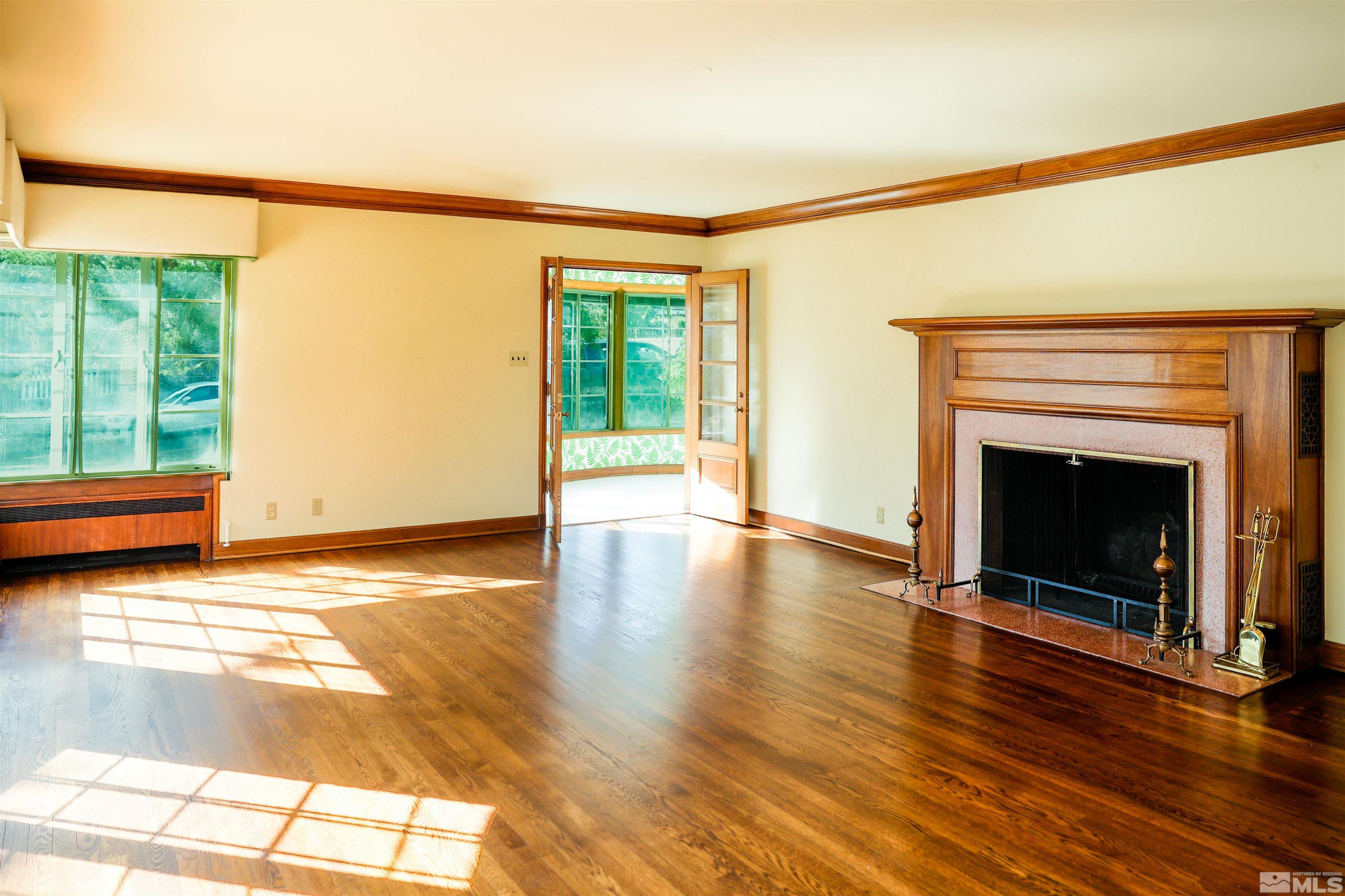 175 Mark Twain Avenue Reno, NV 89509 - Photo 9 of 27 a view of an empty room with wooden floor and a window