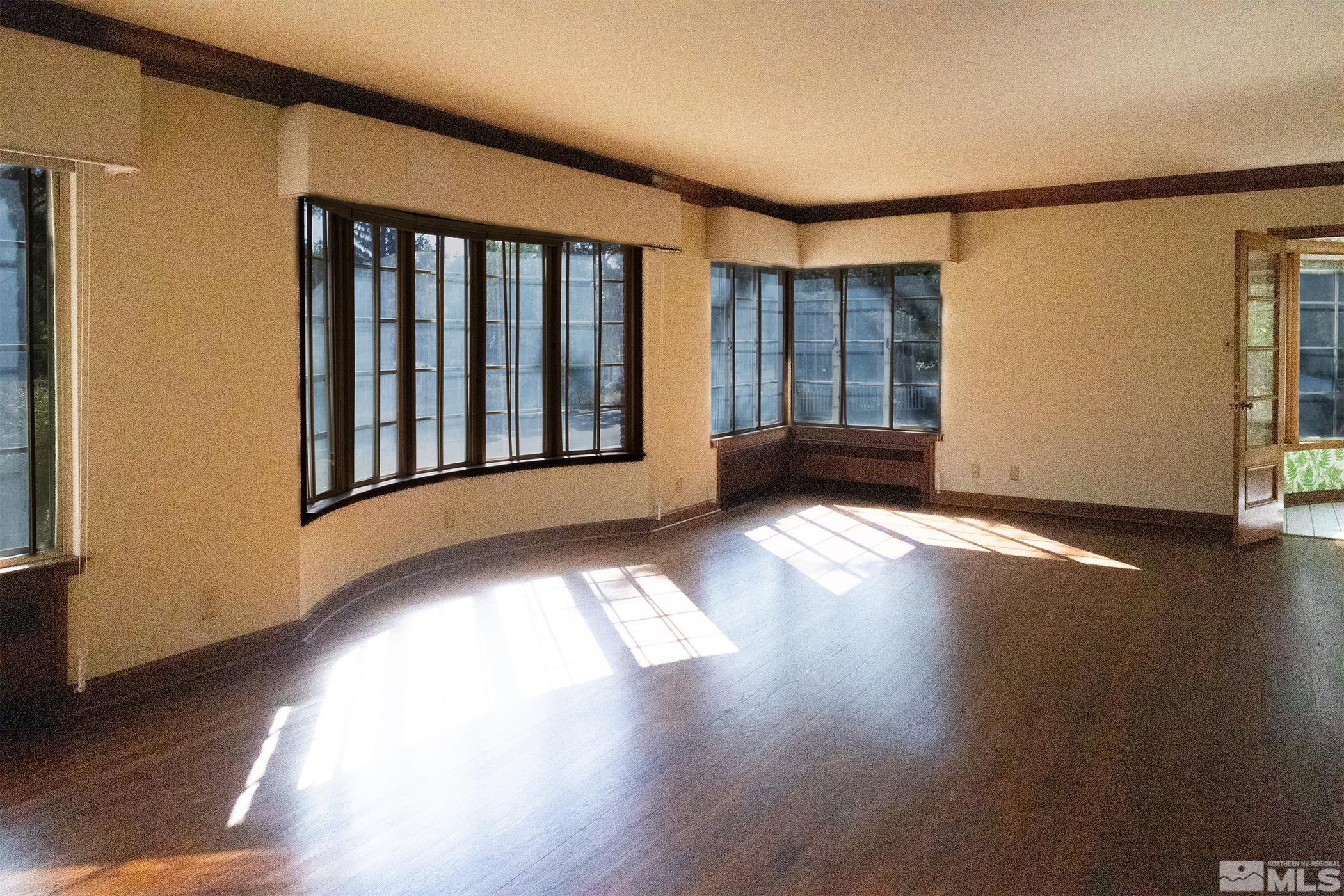 175 Mark Twain Avenue Reno, NV 89509 - Photo 10 of 27 a view of an empty room with wooden floor and a window