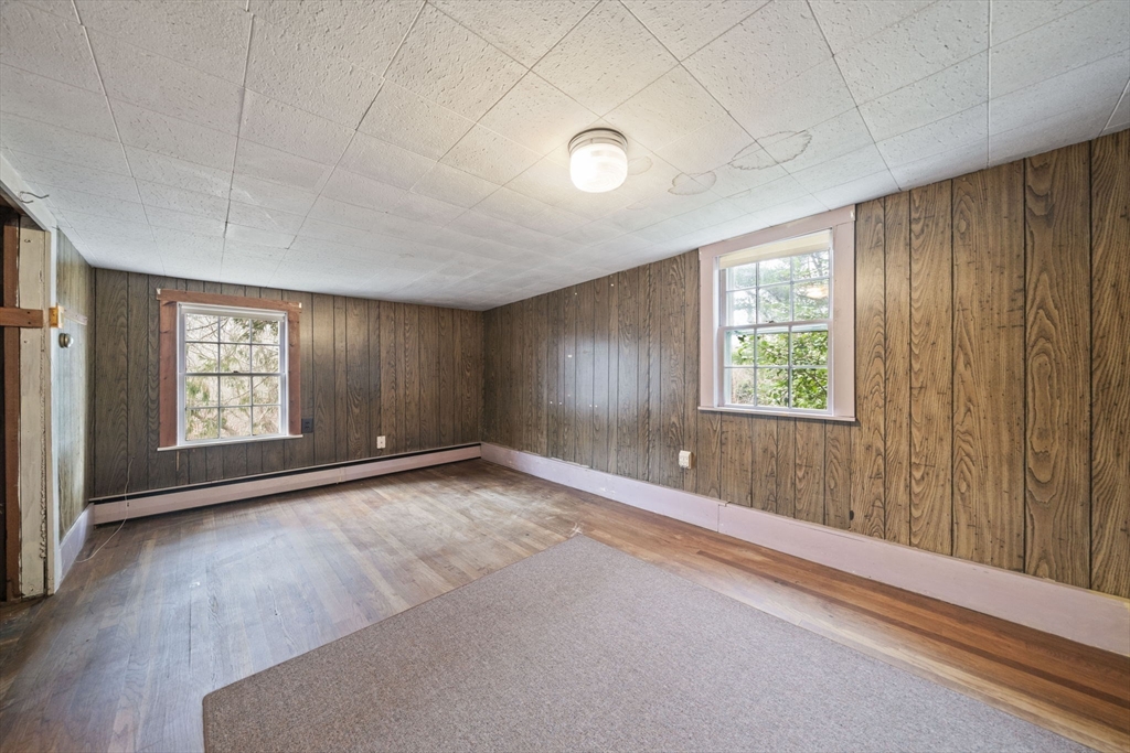 764 First Parish Road Scituate, MA 02066 - Photo 6 of 13 an empty room with wooden floor and windows