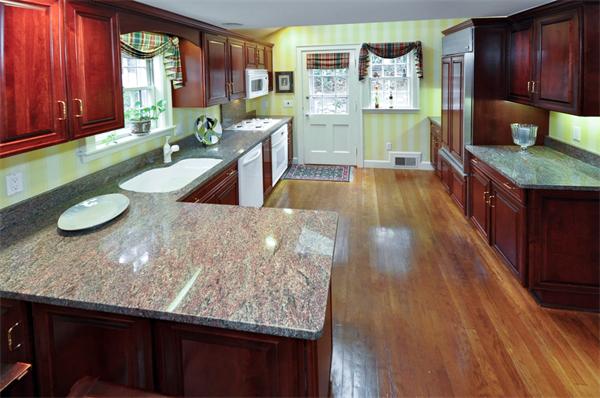 7 Monroe Road Wellesley, MA 02481 - Photo 5 of 22 a kitchen with granite countertop wooden floors wooden cabinets a sink and a stove