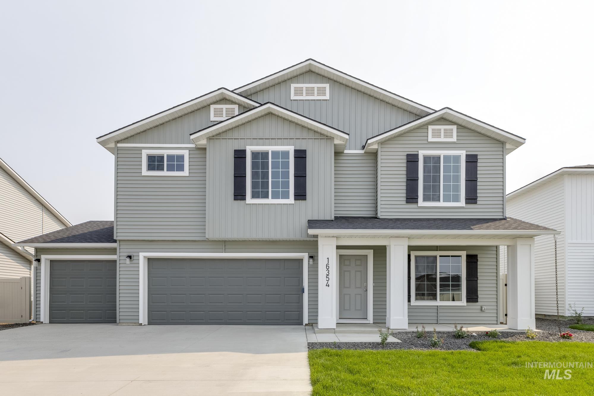 View of front of home featuring a porch, a shingled roof, concrete driveway, and an attached garage