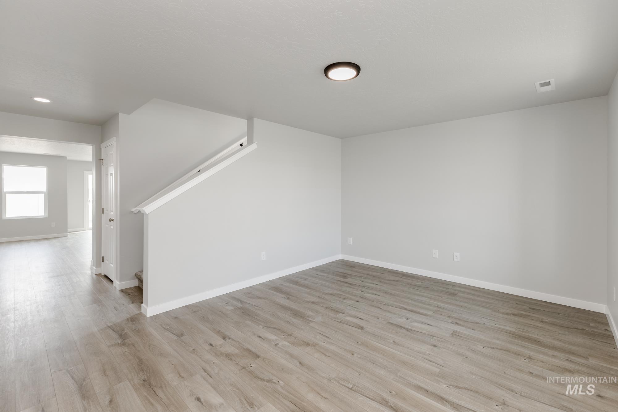 16354 Backfill Avenue Caldwell, ID 83607 - Photo 10 of 25 Below grade area featuring light wood finished floors and stairs