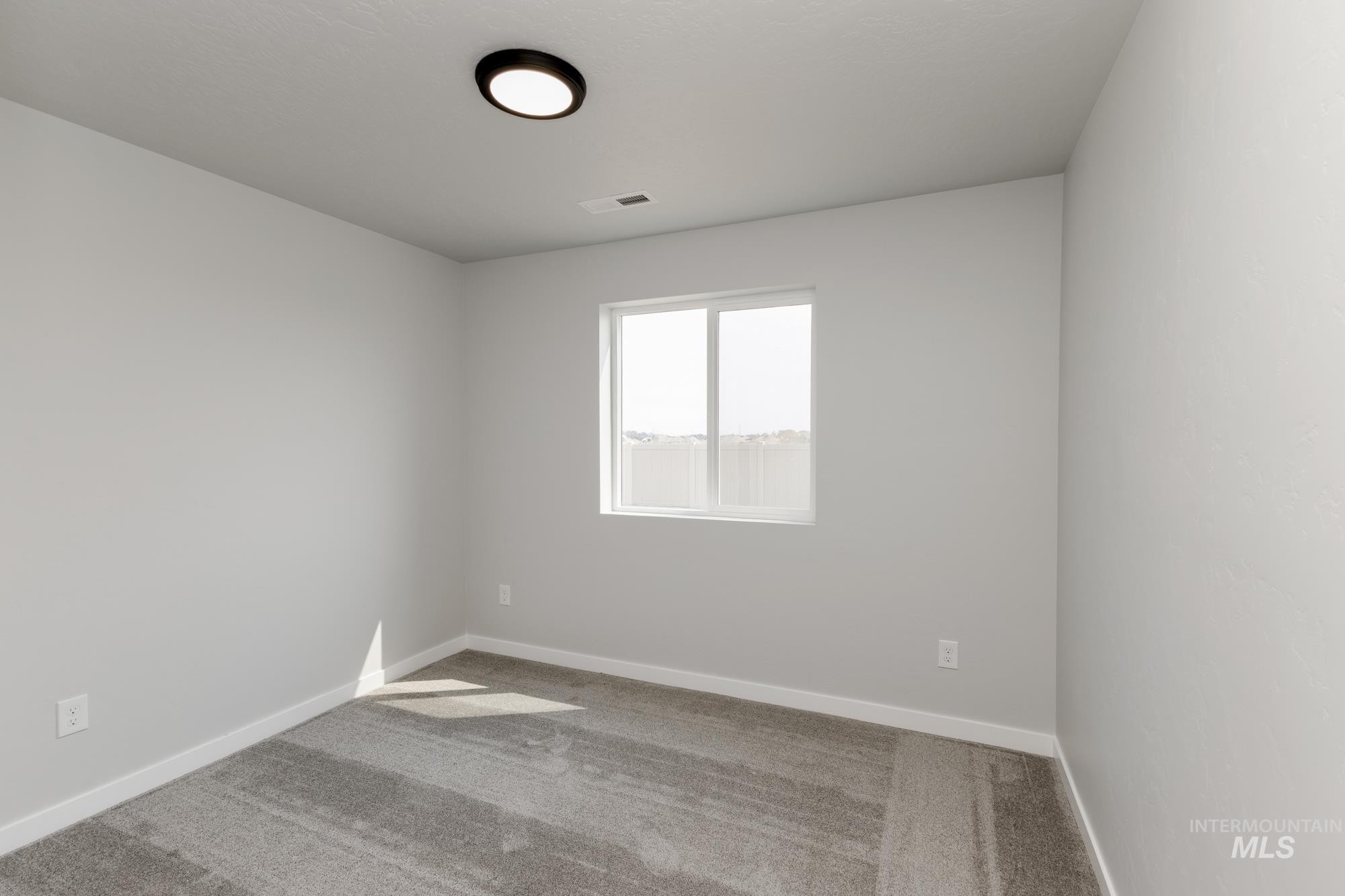 16354 Backfill Avenue Caldwell, ID 83607 - Photo 11 of 25 Carpeted spare room featuring baseboards