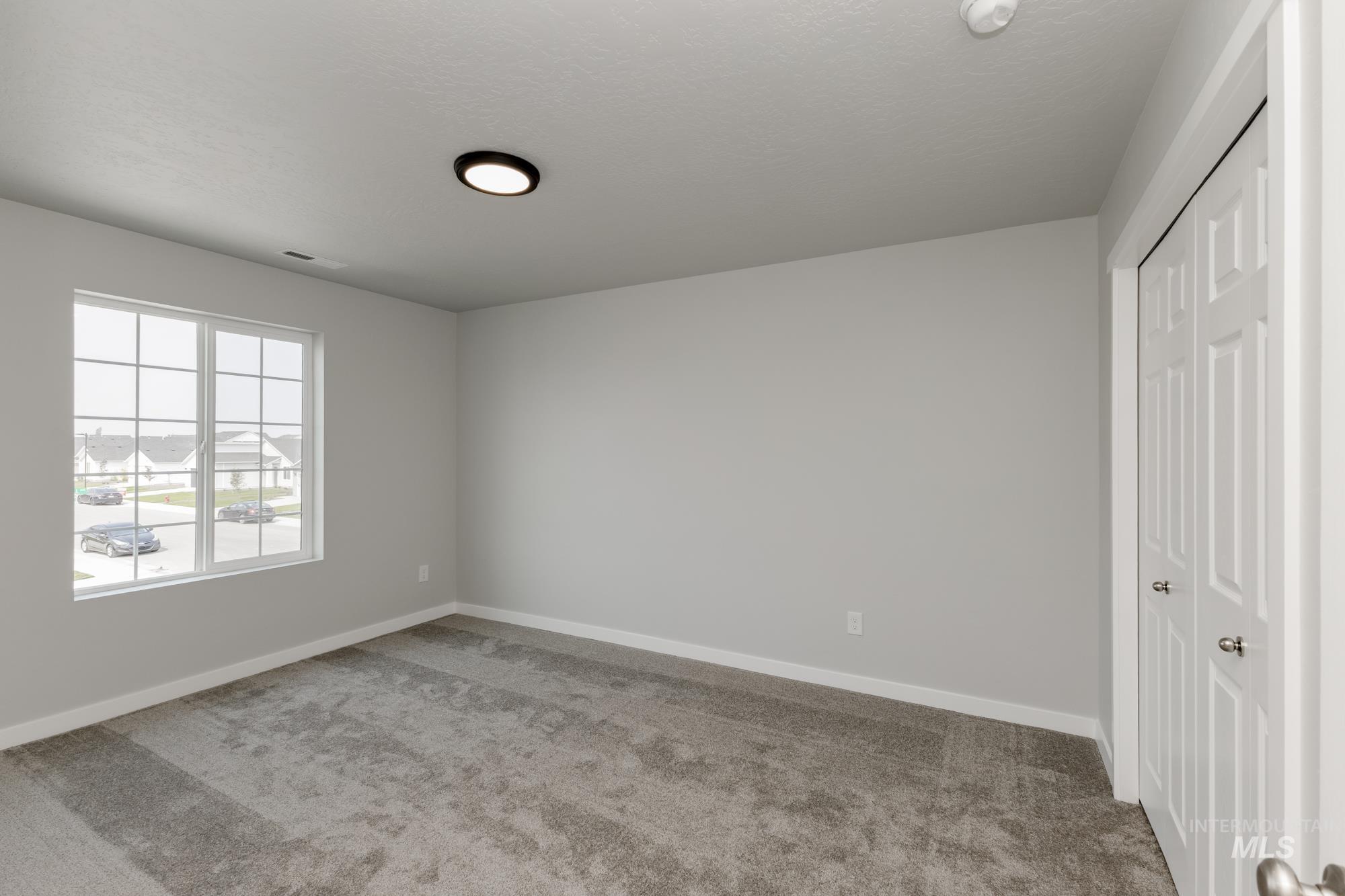 16354 Backfill Avenue Caldwell, ID 83607 - Photo 17 of 25 Unfurnished bedroom featuring carpet and a closet