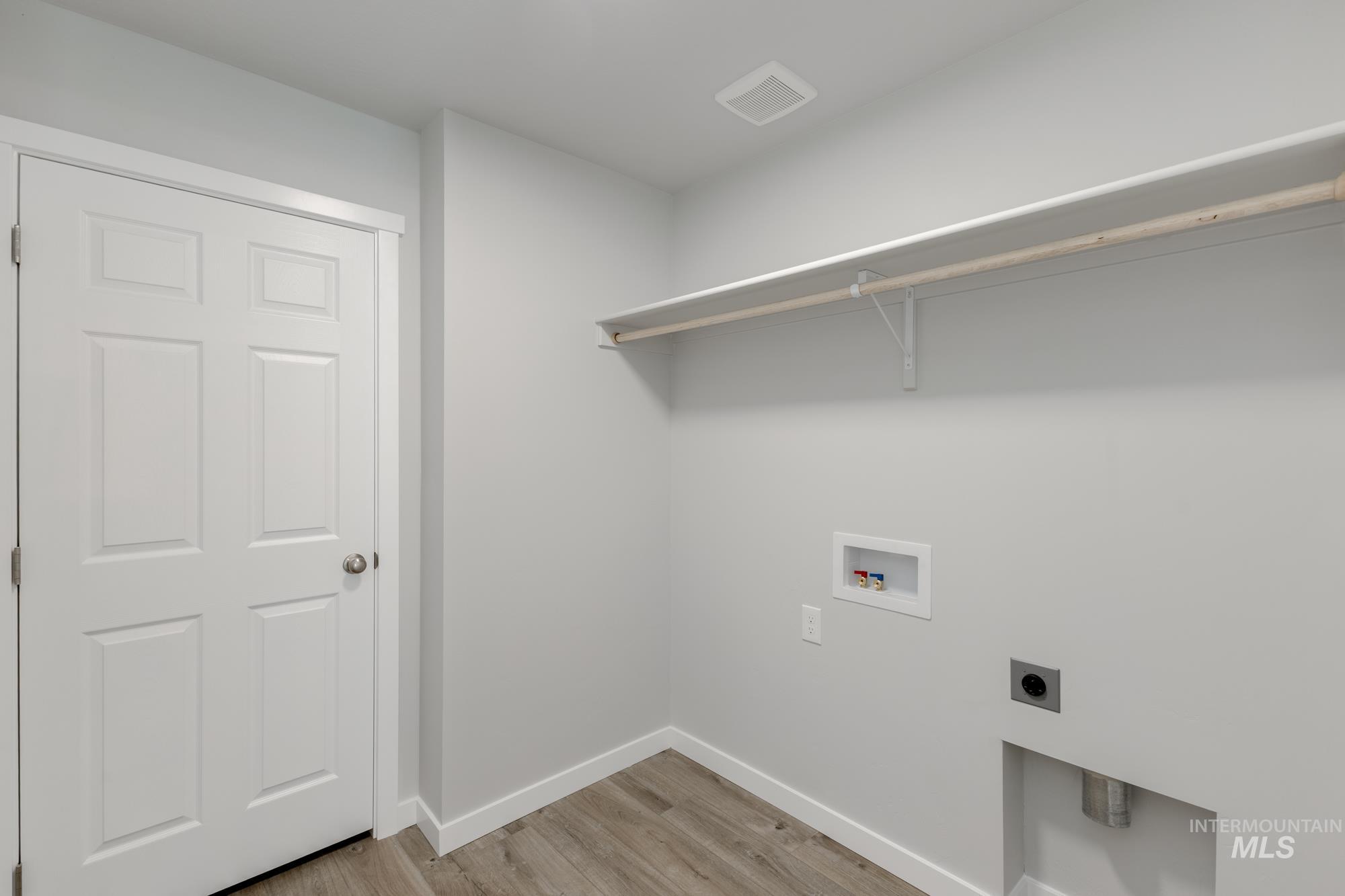 16354 Backfill Avenue Caldwell, ID 83607 - Photo 19 of 25 Laundry area featuring light wood finished floors, washer hookup, and hookup for an electric dryer