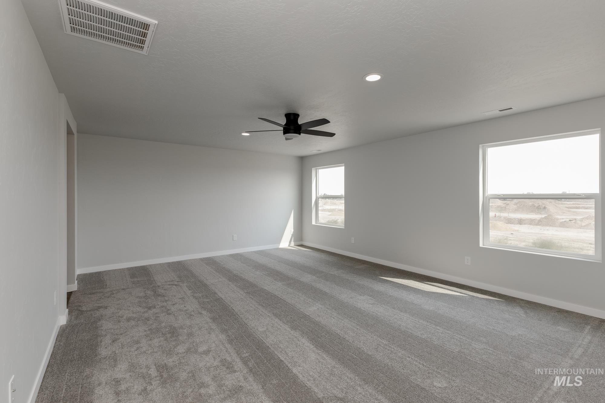 16354 Backfill Avenue Caldwell, ID 83607 - Photo 20 of 25 Empty room with light carpet, ceiling fan, and recessed lighting