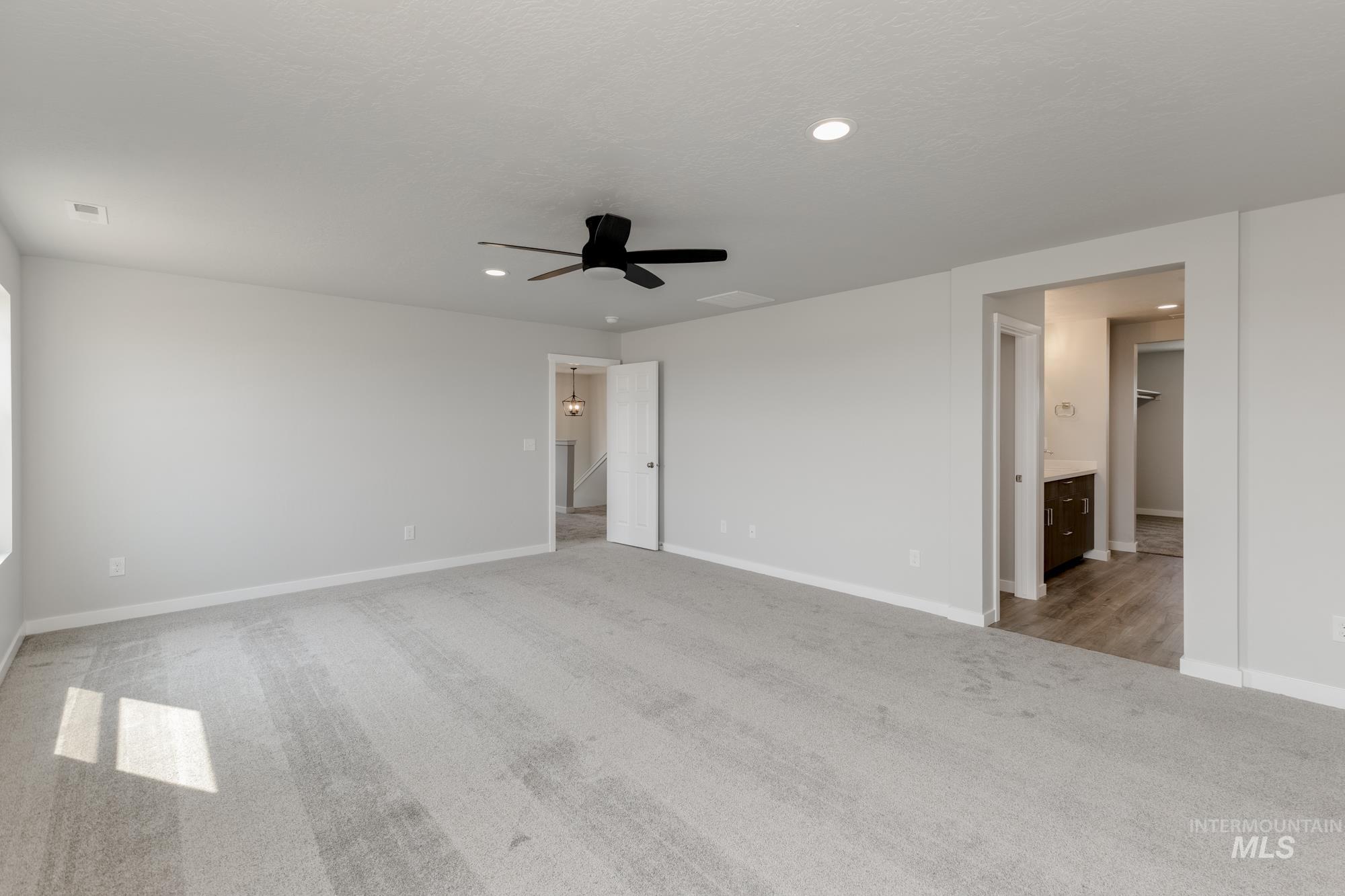 16354 Backfill Avenue Caldwell, ID 83607 - Photo 21 of 25 Unfurnished bedroom with light carpet, recessed lighting, connected bathroom, and a ceiling fan