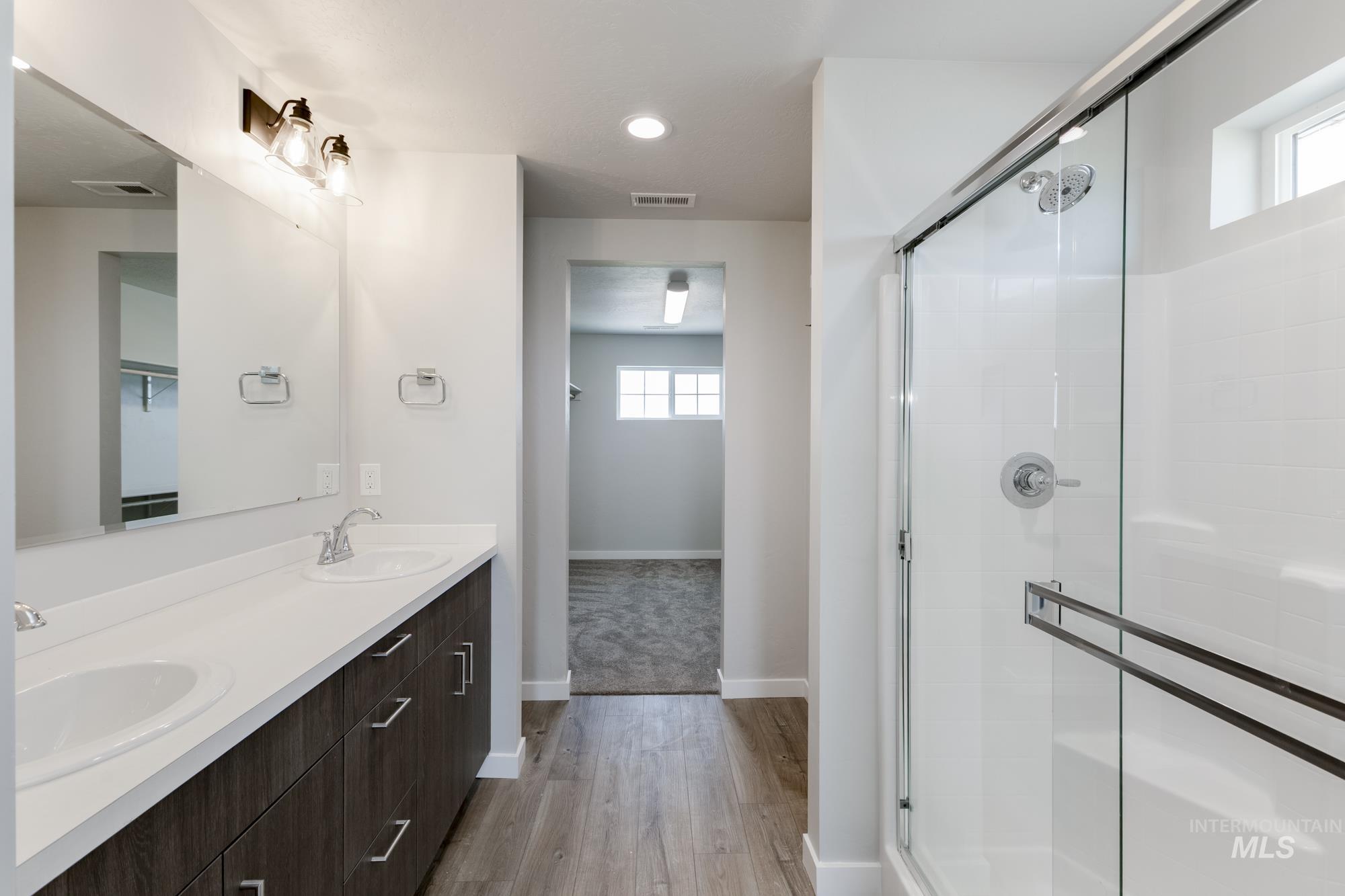 16354 Backfill Avenue Caldwell, ID 83607 - Photo 22 of 25 Full bath featuring a stall shower, double vanity, light wood finished floors, and recessed lighting