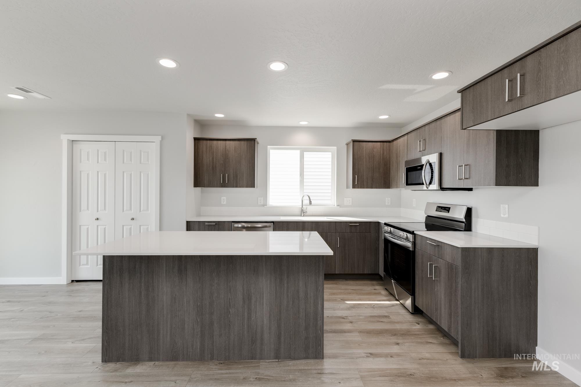 16354 Backfill Avenue Caldwell, ID 83607 - Photo 5 of 25 Kitchen with modern cabinets, stainless steel appliances, recessed lighting, a center island, and light wood-style flooring
