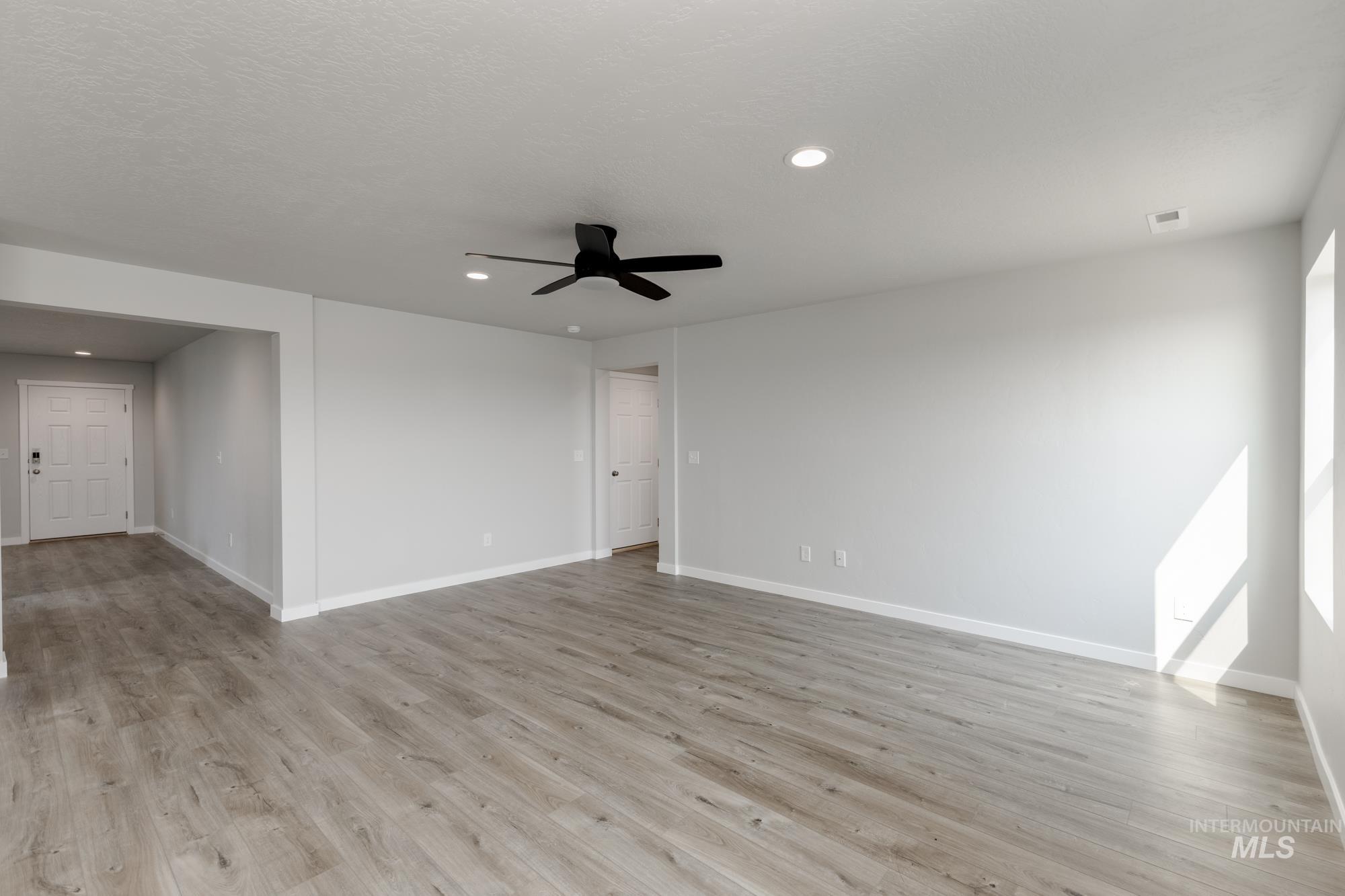 16354 Backfill Avenue Caldwell, ID 83607 - Photo 9 of 25 Empty room featuring recessed lighting, light wood finished floors, and a ceiling fan