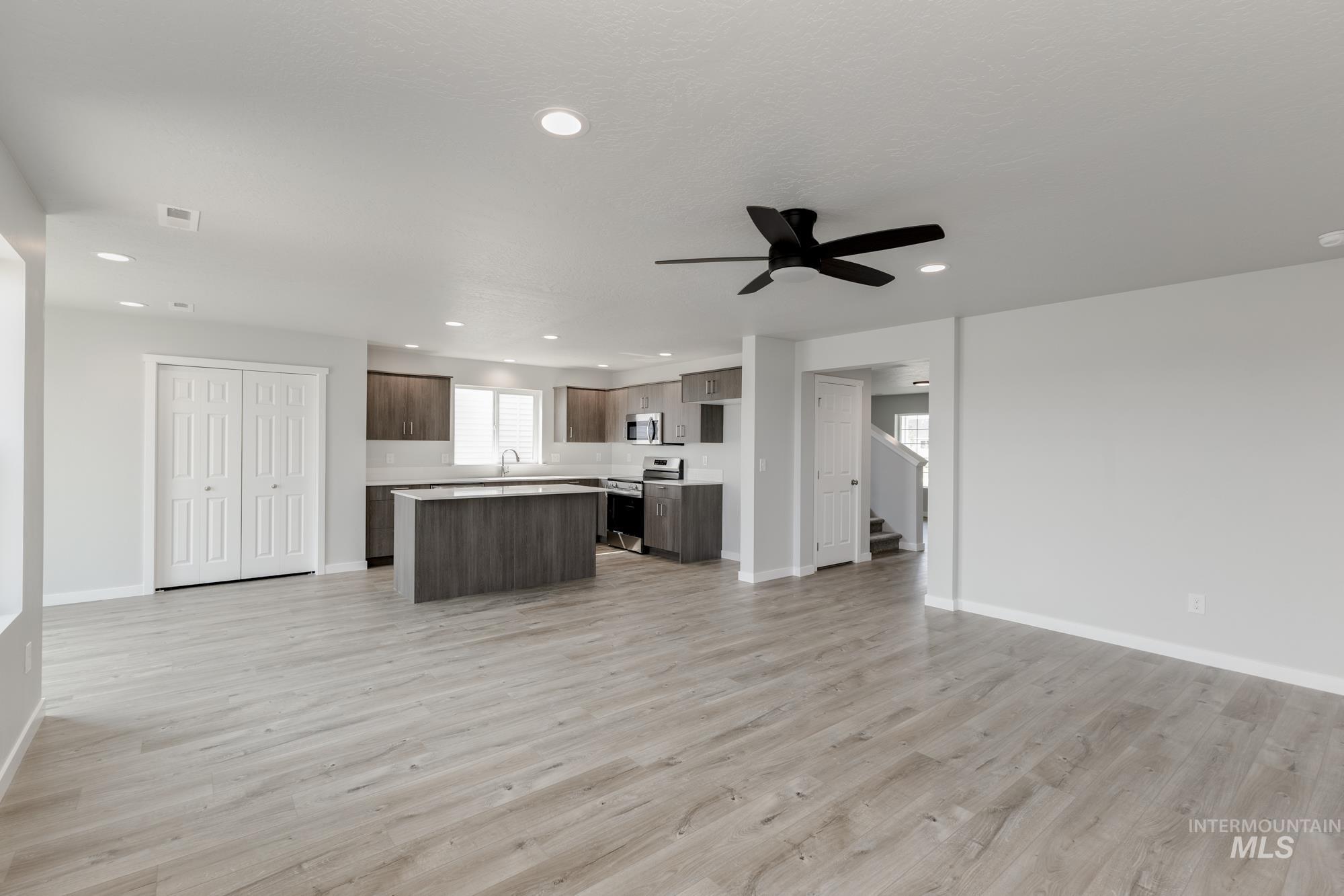 16354 Backfill Avenue Caldwell, ID 83607 - Photo 25 of 25 Kitchen featuring open floor plan, light countertops, a kitchen island, dark brown cabinetry, and recessed lighting