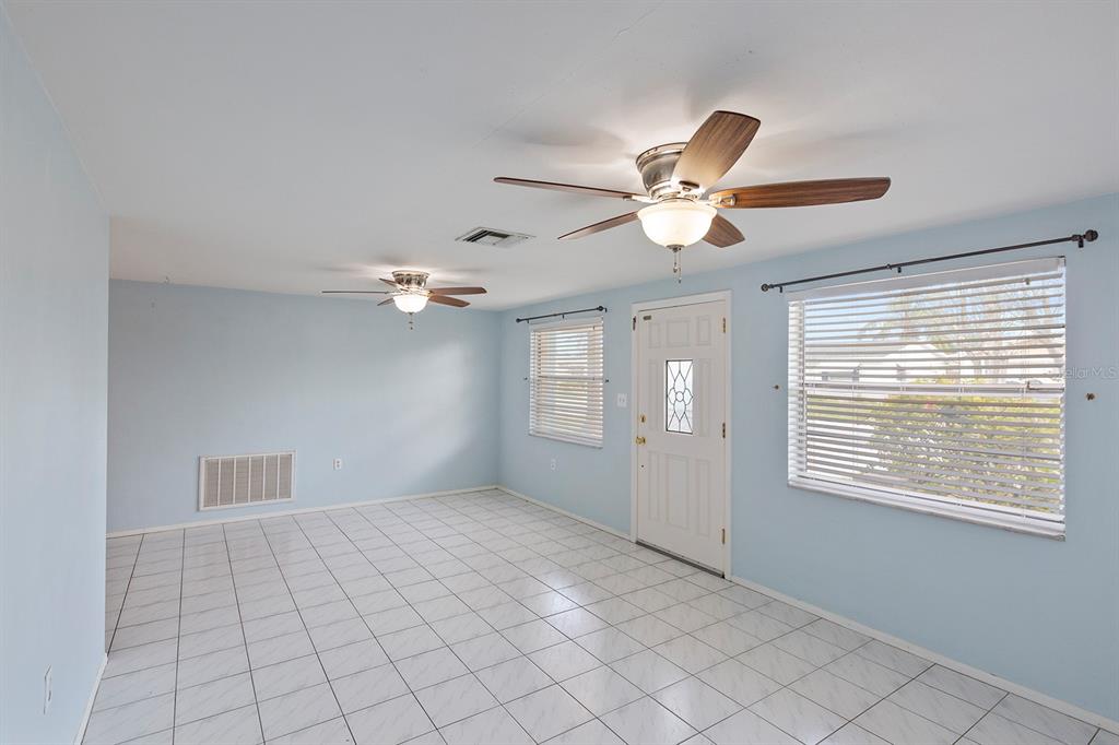 3128 Kilburn Road Holiday, FL 34691 - Photo 4 of 28 a view of an empty room with a ceiling fan and window
