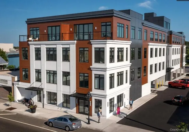 a front view of a building with parking space