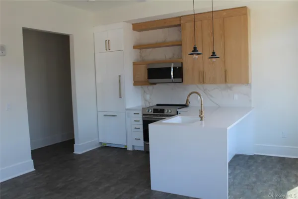 a kitchen with stainless steel appliances a sink and a refrigerator