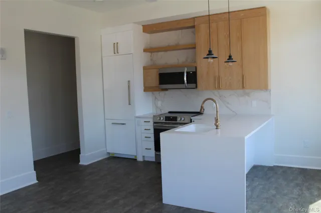 a kitchen with stainless steel appliances a sink and a refrigerator