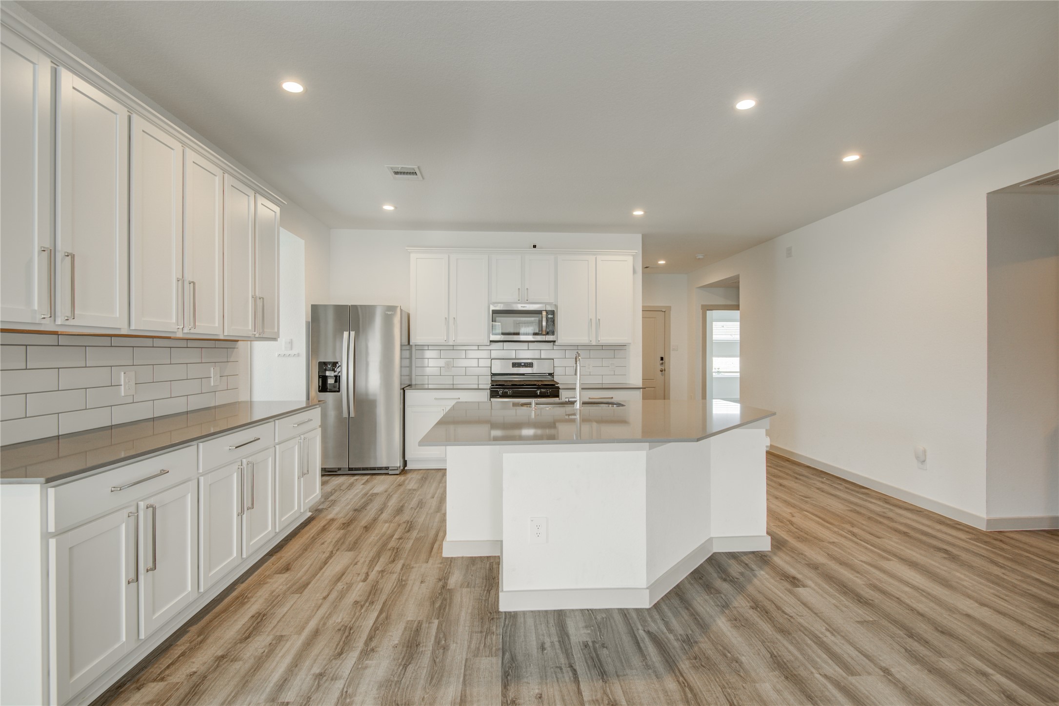 7802 Murciana Drive Rosharon, TX 77583 - Photo 17 of 35 a kitchen with stainless steel appliances wooden floors and wooden cabinets