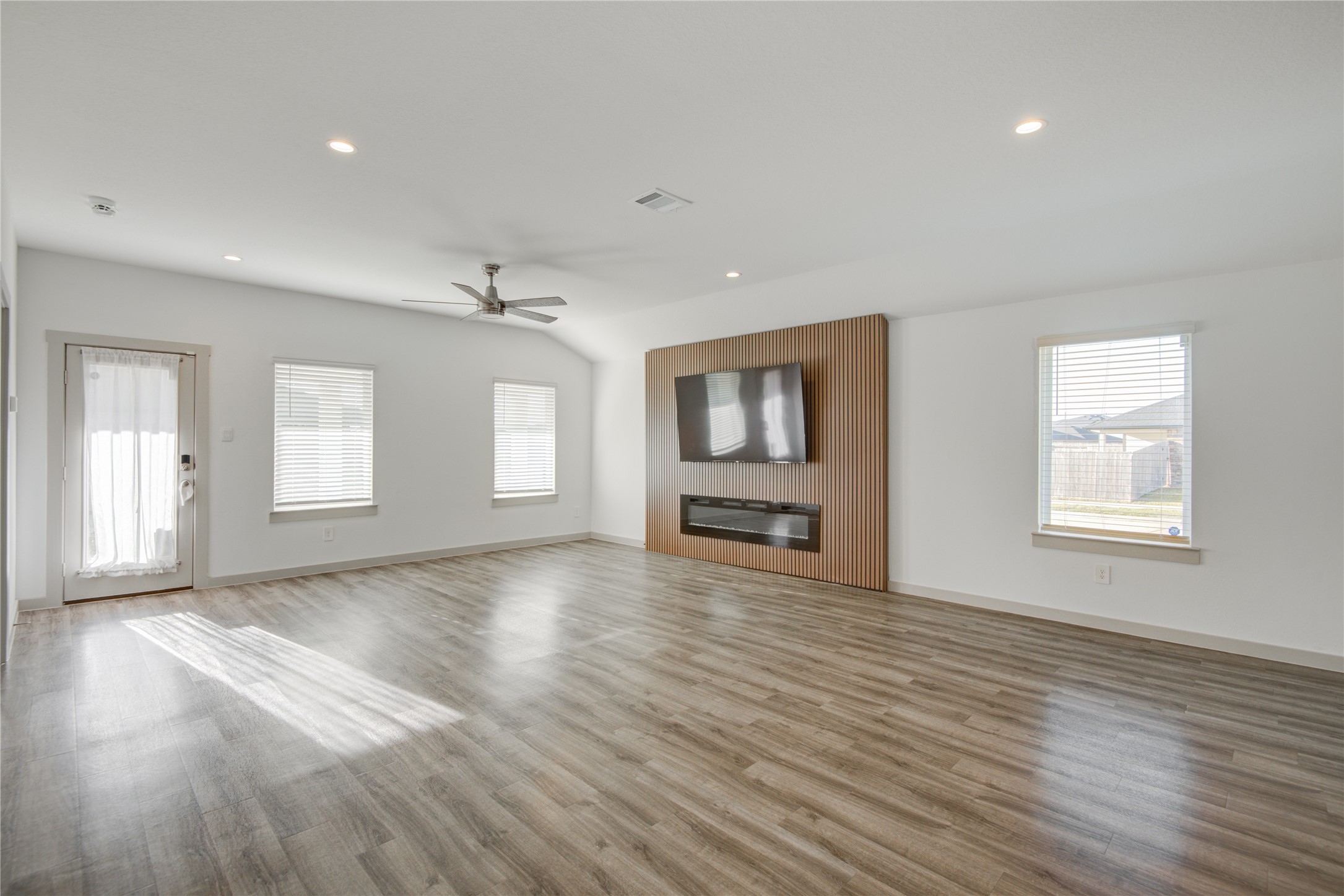 7802 Murciana Drive Rosharon, TX 77583 - Photo 22 of 35 a view of an empty room with a window and wooden floor