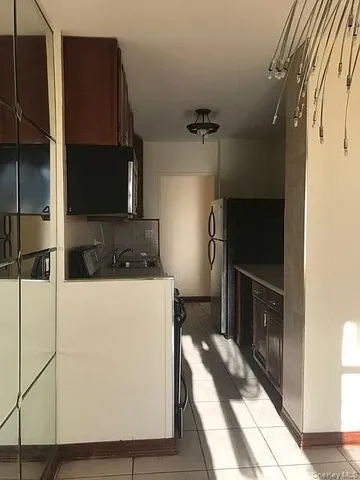 a kitchen with a refrigerator and a stove