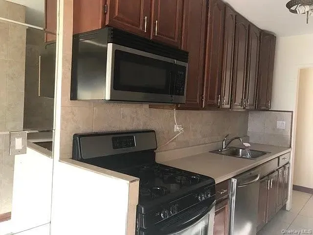 a kitchen with granite countertop a stove and a microwave