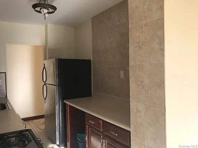 a kitchen with a refrigerator and a stove