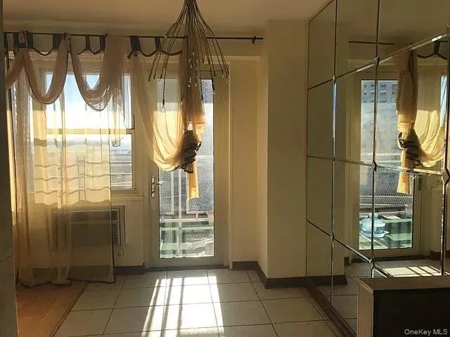 a bathroom with a glass shower door and a window