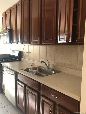a kitchen with stainless steel appliances a sink dishwasher and cabinets
