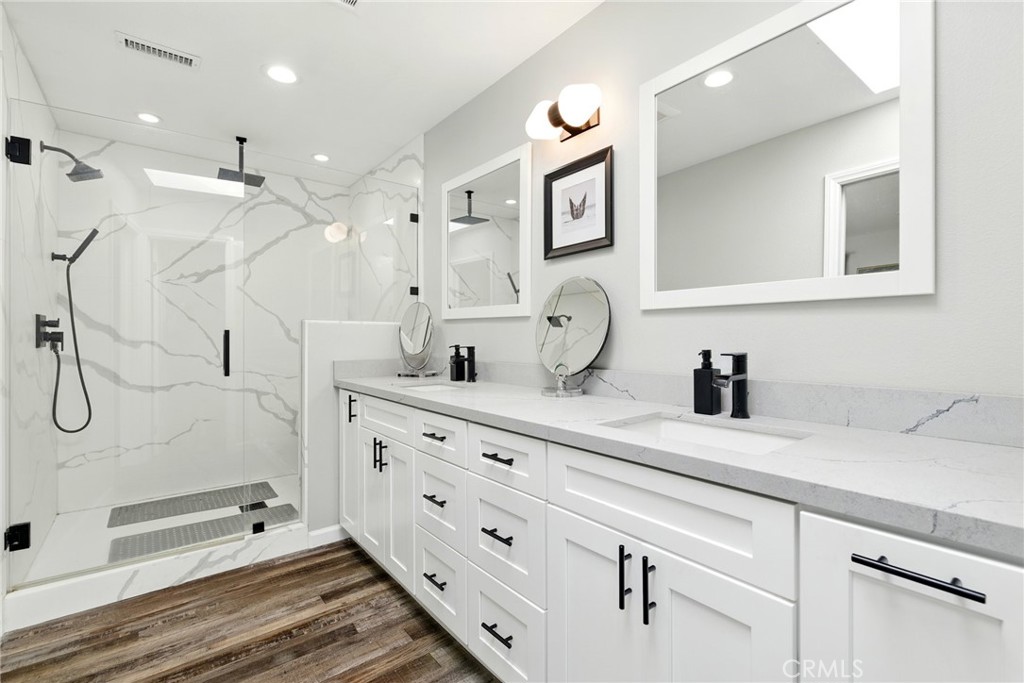 3101 Maple Avenue Fullerton, CA 92835 - Photo 19 of 46 a bathroom with a granite countertop sink a mirror a vanity and shower