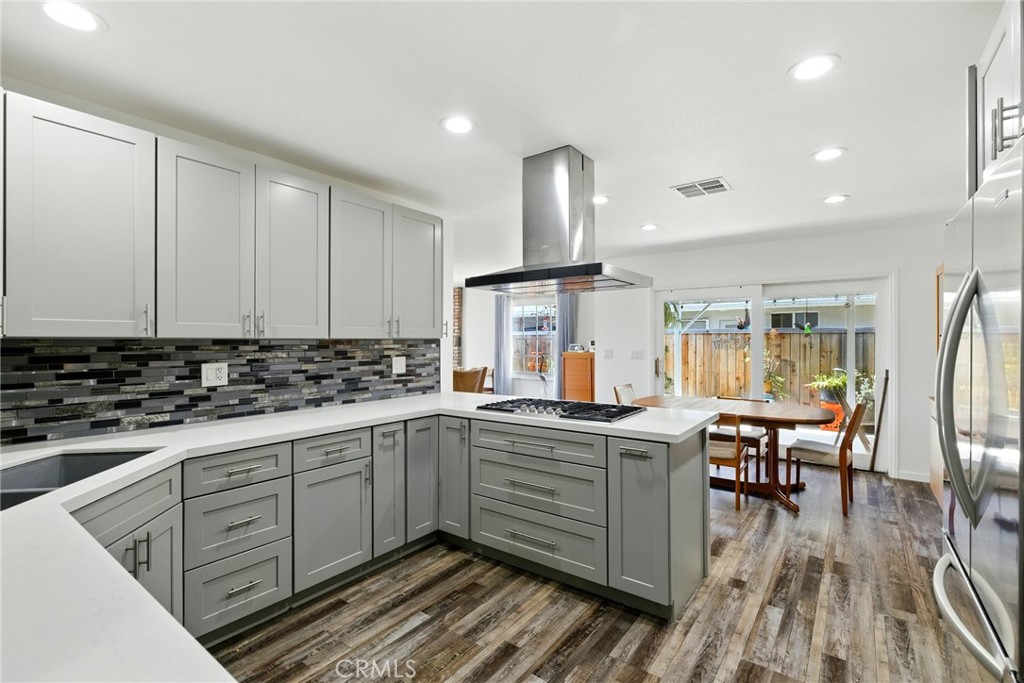 3101 Maple Avenue Fullerton, CA 92835 - Photo 2 of 46 a kitchen with stainless steel appliances granite countertop a sink and wooden cabinets