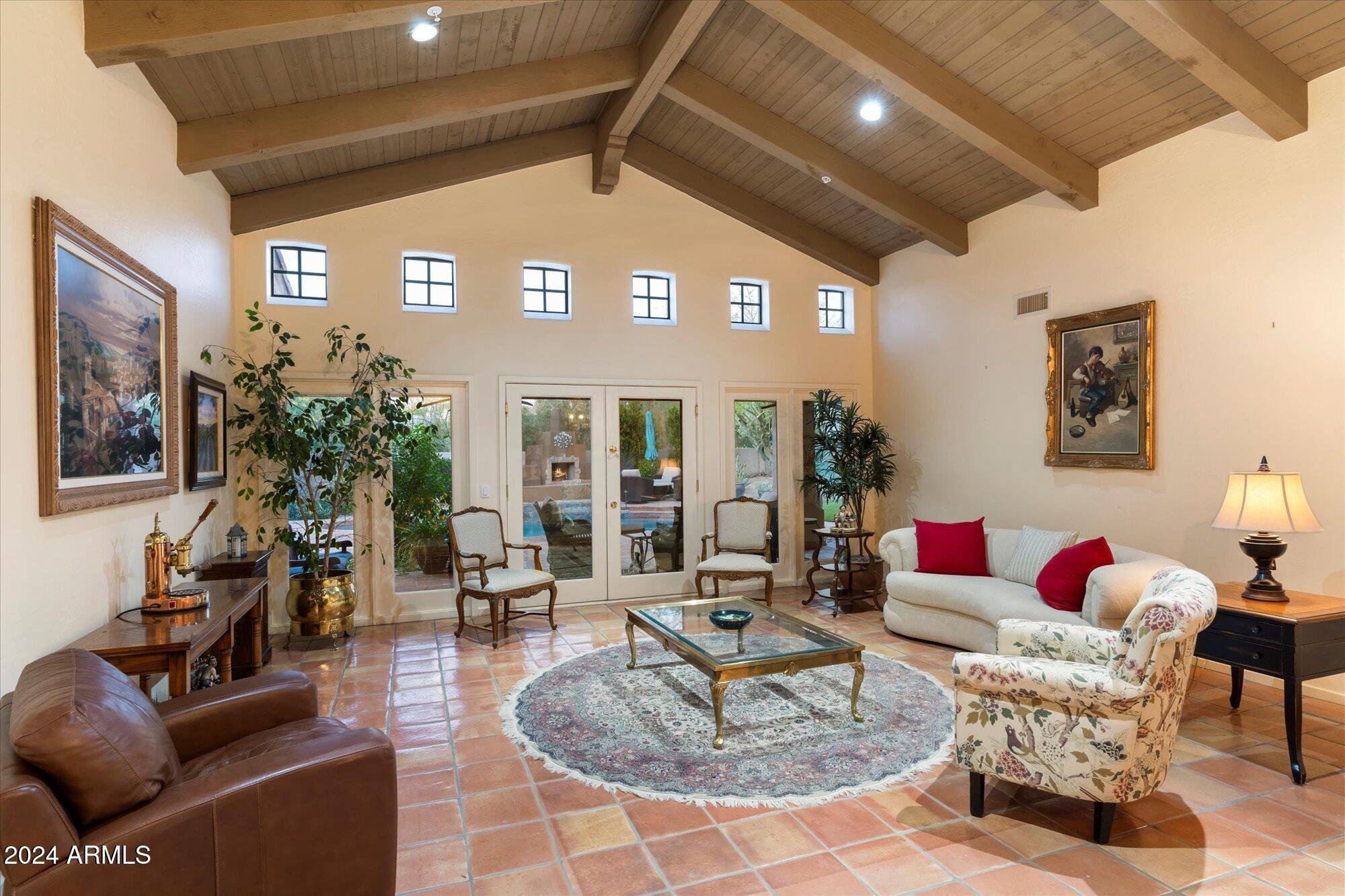 25255 North Ranch Gate Road Scottsdale, AZ 85255 - Photo 12 of 68 a living room with furniture a rug and a potted plant