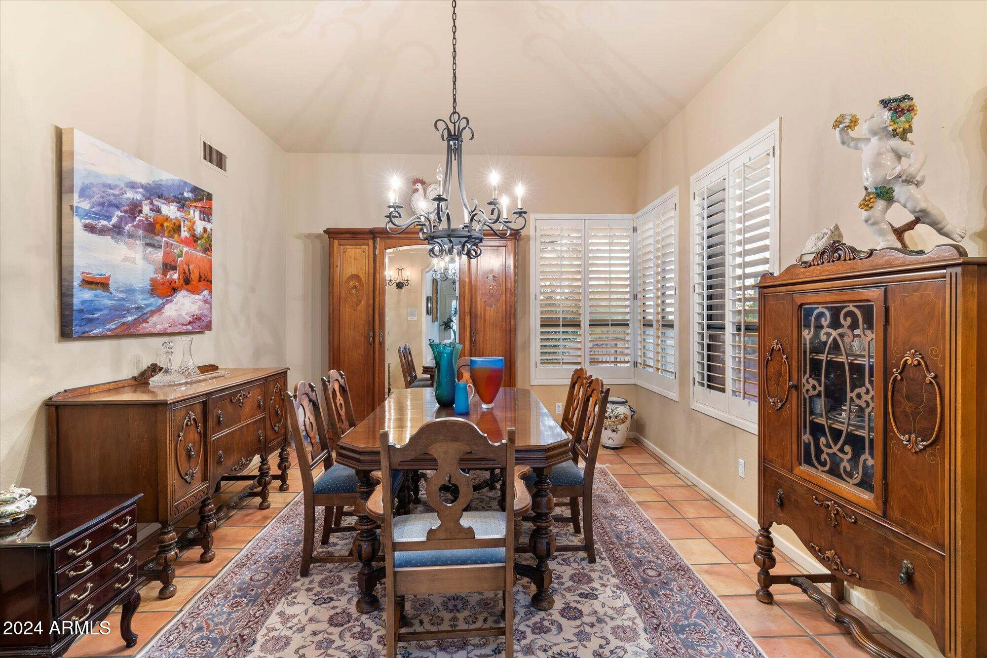 25255 North Ranch Gate Road Scottsdale, AZ 85255 - Photo 15 of 68 a view of a dining room with furniture window and wooden floor