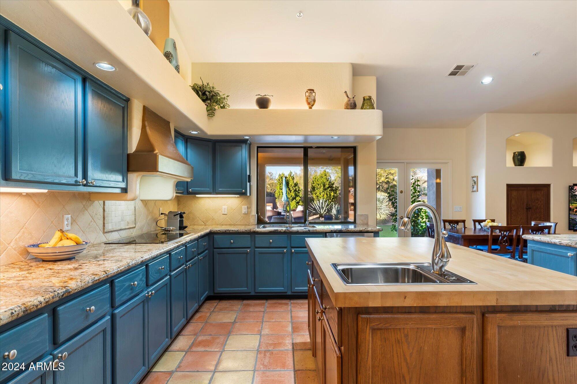 25255 North Ranch Gate Road Scottsdale, AZ 85255 - Photo 17 of 68 a kitchen with a sink a stove and cabinets
