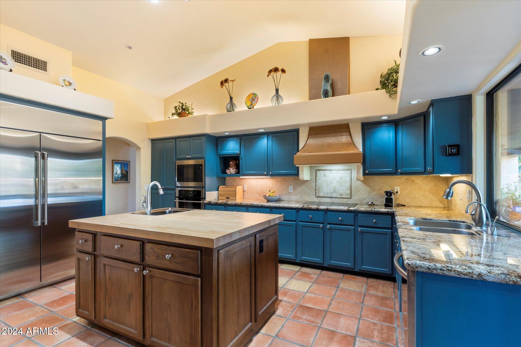 25255 North Ranch Gate Road Scottsdale, AZ 85255 - Photo 18 of 68 a kitchen with a sink a stove and cabinets