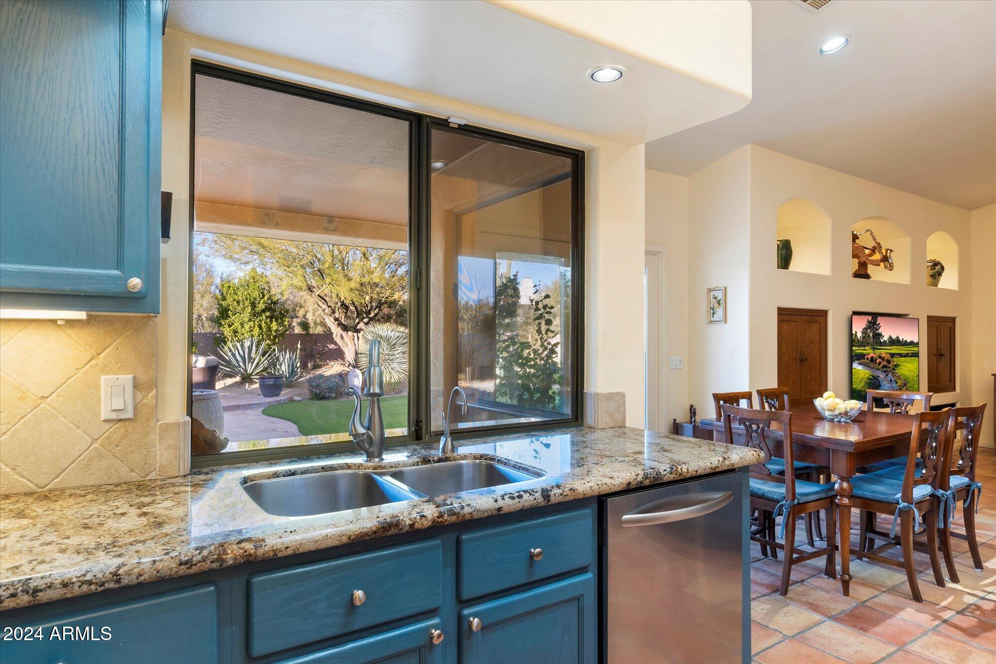 25255 North Ranch Gate Road Scottsdale, AZ 85255 - Photo 19 of 68 a kitchen with granite countertop a sink and a window
