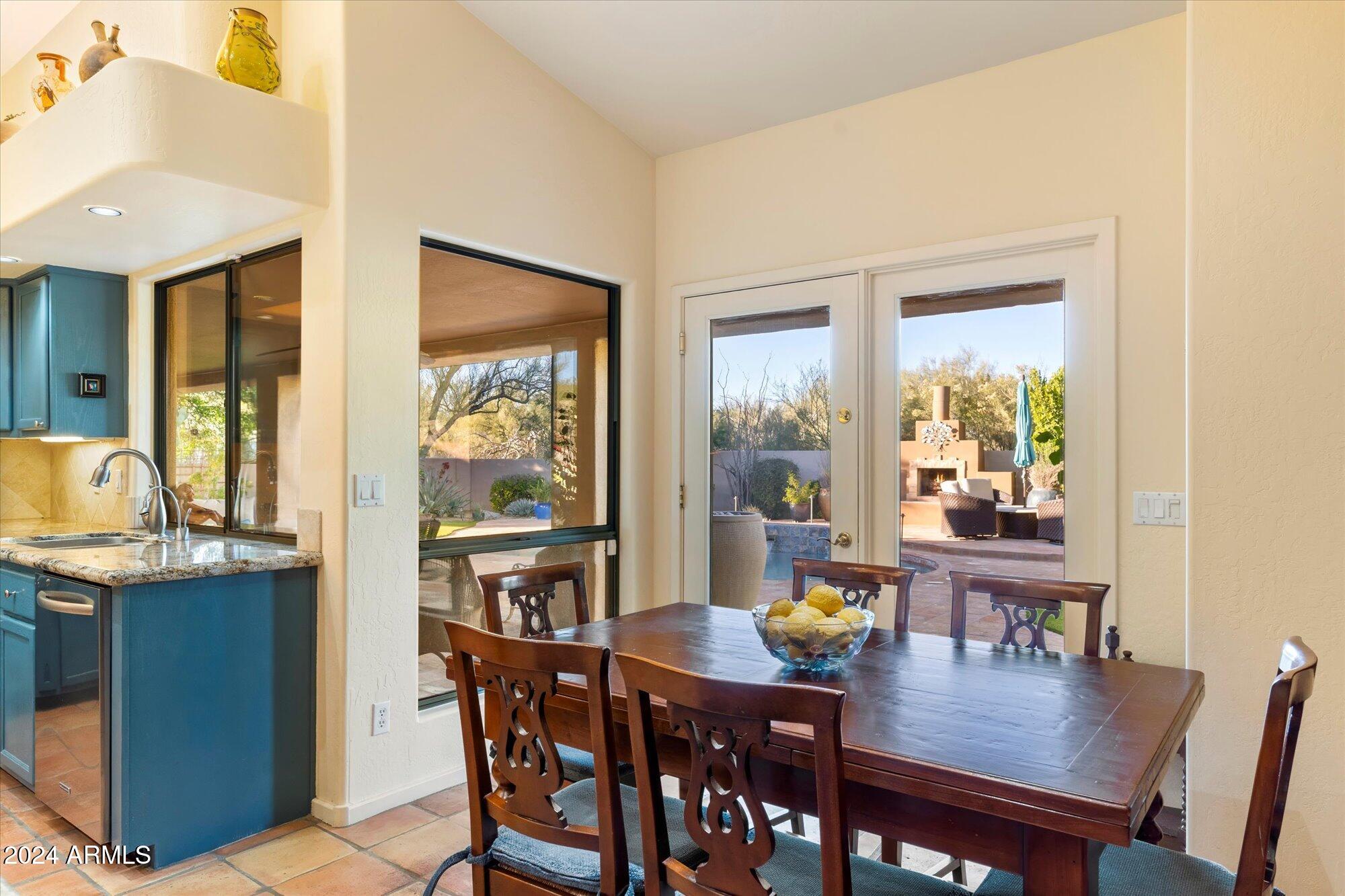25255 North Ranch Gate Road Scottsdale, AZ 85255 - Photo 21 of 68 a view of a dining room with furniture window and wooden floor